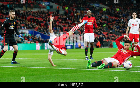 London, UK. 26th Feb, 2017. Southampton's Maya Yoshida (L) is tackled down by Manchester United's Marcos Rojo during the EFL Cup Final between Manchester United and Southampton at Wembley Stadium in London, Britain on Feb. 26, 2017. Credit: Han Yan/Xinhua/Alamy Live News Stock Photo