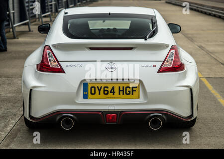 Rear, back of a white Nissan 370z NISMO Facelift on track at Rockingham Raceway Corby England Stock Photo