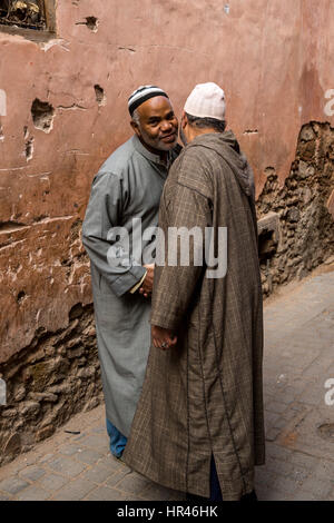 Marrakesh, Morocco.  Two Men Greeting Each Other in the Street. Stock Photo