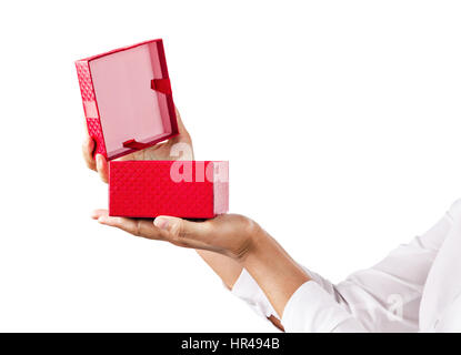 Hands holding an opened red gift box isolated on white background, Saved clipping path. Stock Photo