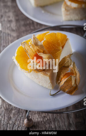 Cheesecake decorated with oranges and physalis Stock Photo