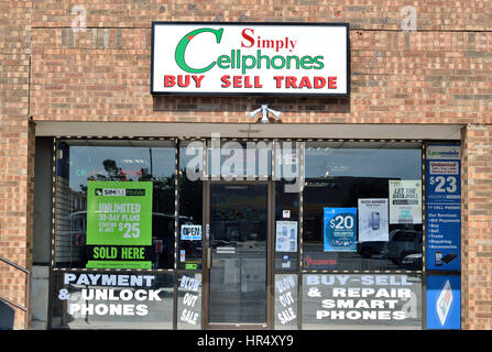 Storefront of a cell phone repair store in a strip mall Stock Photo