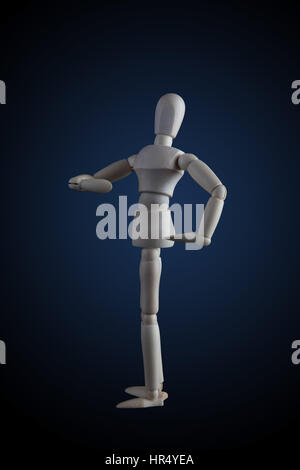 Wooden figurine flexing muscles in bodybuilder pose on dark background Stock Photo