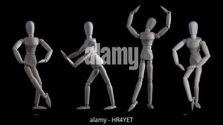 Set of wooden figurines in elegant dance move poses isolated on black background Stock Photo