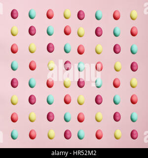 Rows of colorful Easter eggs isolated over a pink background. Flat lay style. Stock Photo
