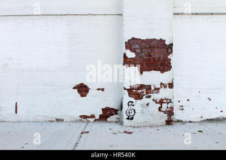 Peeling painted brick wall in Brooklyn Stock Photo