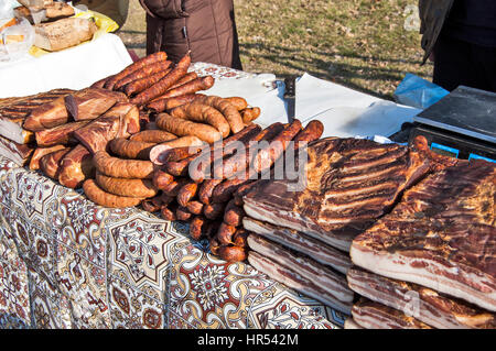 Domestic smoked bacon and other traditional smoked products exposed to sale. Stock Photo