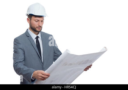 Diligent professional. Handsome mature bearded male architect wearing hardhat looking serious while examining blueprints isolated on white professiona Stock Photo