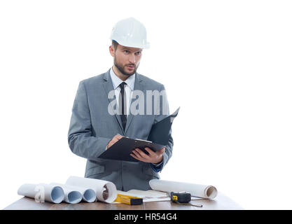 Engineering notes. Mature businessman engineer looking away thoughtfully while writing on his clipboard profession development building architectural  Stock Photo