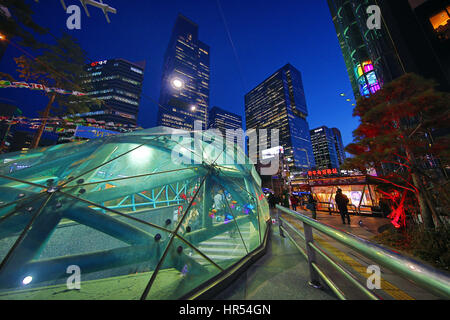 Tall modern buildings and office blocks at dusk with the glass of Gangnam metro station in the Gangnam district, Seoul, Korea Stock Photo