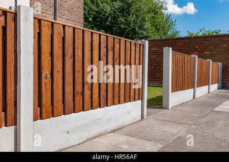 Wooden garden fence with concrete posts Stock Photo