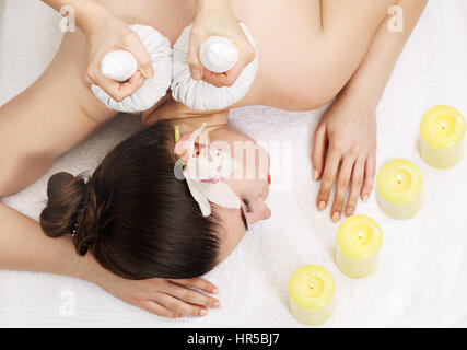 Thai Ball Massage. Woman getting SPA thai herbal compress massage. Top view Stock Photo