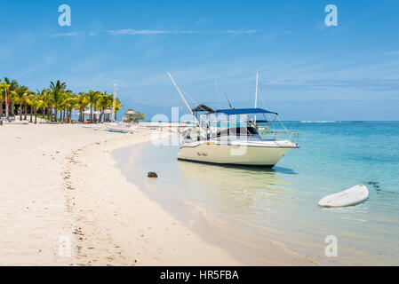 Le Morne, Mauritius - December 7, 2015: A sunny day with speed boat on the Le Morne Beach, one of the finest beaches in Mauritius and the site of many Stock Photo