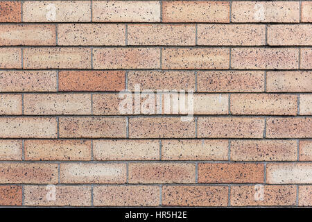 Yellow variegated brick wall. Stock Photo