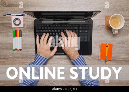 Male hand typing on laptop, message ONLINE STUDY Stock Photo