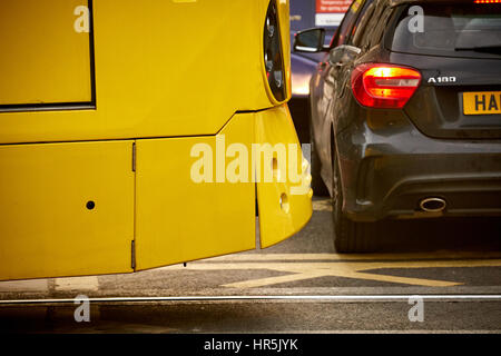 A yellow Metrolink tram stop by force as a car blocked its path by parking on a box junction in Manchester city centre, England, UK. Stock Photo