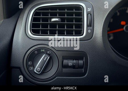 Automotive air conditioning. The flow of air inside the vehicle. headlamp switch. Detail of the interior of the car Stock Photo