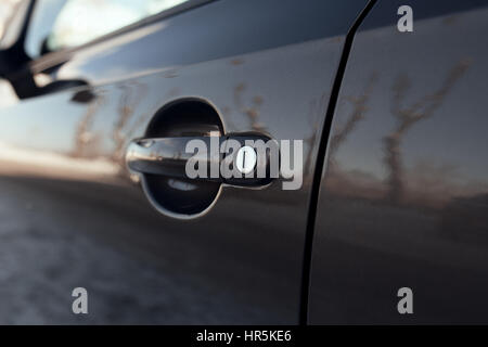 external handle of opening a car door with a keyhole closeup Stock Photo