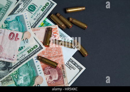 Used Bulet Shell The used bullet shells and dollars Stock Photo - Alamy