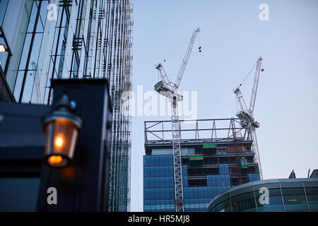 Tower Cranes working what was Quay House in Spinningfiled,  The Avenue, Manchester, England,UK Stock Photo