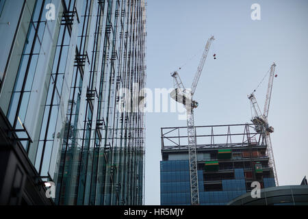 Tower Cranes working what was Quay House in Spinningfiled,  The Avenue, Manchester, England,UK Stock Photo