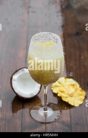 Pina colada cocktail on a wooden table. Rustic style. Stock Photo