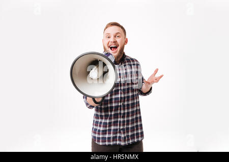 Happy Bearded man in shirt using megaphone in studio. Isolated white background Stock Photo