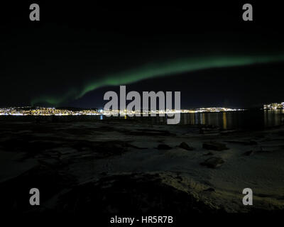 aurora borealis at night in tromsoe city with full moon
