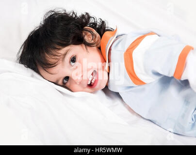 cute boy lying down over white Stock Photo