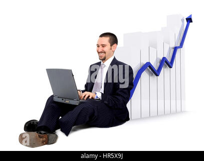 business man on a laptop sitting on the floor with a growth and success chart Stock Photo