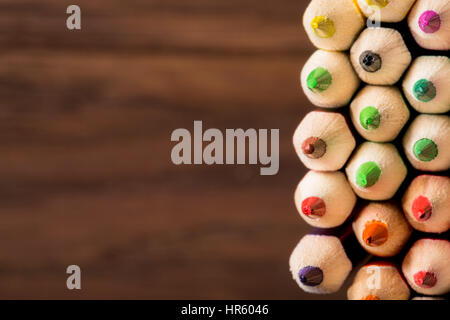 Tips of coloring pencils over a brown textured background. shallow depth of field. Stock Photo