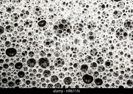 Closeup macro image of multicolored soapy oil bubbles on the surface of water Stock Photo