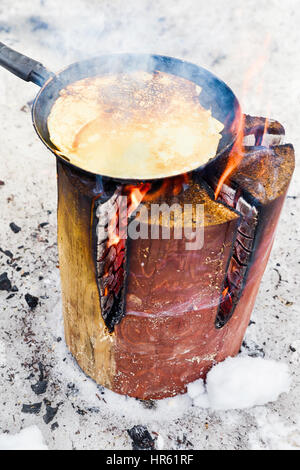 Cooking pancakes on fire Stock Photo