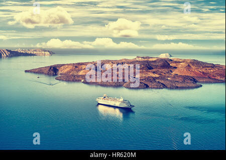 Beautiful landscape with sea view. Cruise liner at the sea near the Nea Kameni, a small  Greek island in the Aegean Sea near Santorini, cyclades, Gree Stock Photo