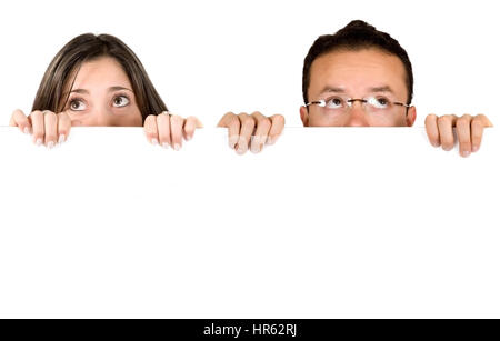 couple holding a white card over a white background Stock Photo