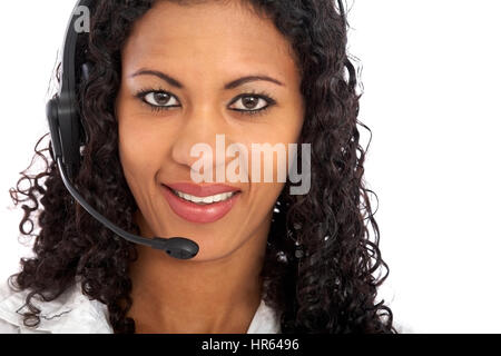 beautiful business customer service woman - smiling and wearing a headset isolated over a white background Stock Photo