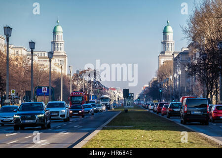 Berlin Friedrichshain,Traffic in busy city street, Karl Marx Allee and twin towers of listed Frankfurter Tor (Gate) building.