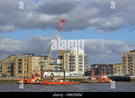 Construction barges on the River Thames in Wapping, London, UK working on the new Thames Tideway sewer tunnel for Thames Water Stock Photo