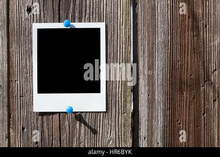 Instant film frame on a wooden wall Stock Photo