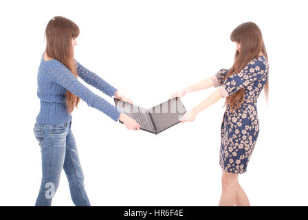 Portrait of two twins sisters with laptop on white background Stock Photo