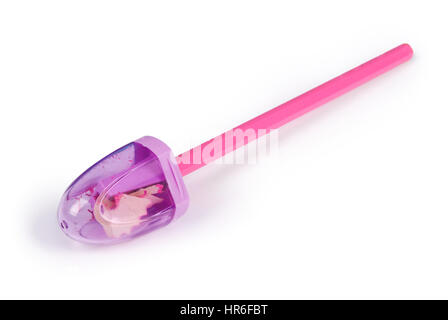 Purple plastic pencil sharpener with red pencil. Closeup with clipping path Stock Photo