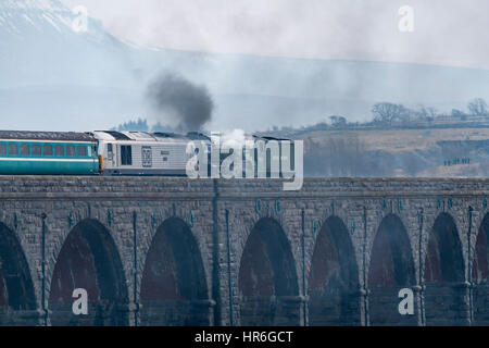 Locomotive, No. 60163 Tornado, a brand new Peppercorn A1 Pacific, travels across the Ribblehead Viaduct with snow-capped Pen-y-Ghent, beyond.