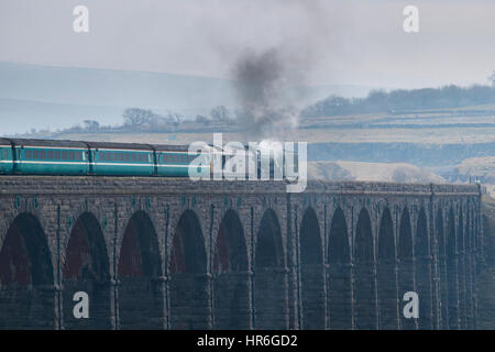 Locomotive, No. 60163 Tornado, a brand new Peppercorn A1 Pacific, travels across the Ribblehead Viaduct on a grey winter day. Stock Photo