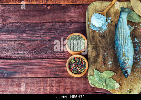 Fresh fish smelt with pepper and a mixture of peppers, empty space on the left Stock Photo