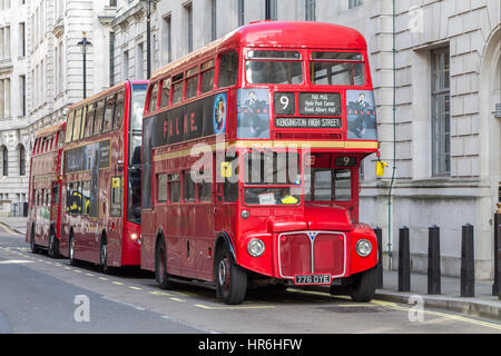 A routemaster bus parked on a central London street with two other buses Stock Photo