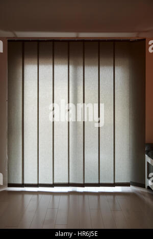 Back lit vertical patio windows blind in gray color Stock Photo
