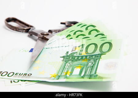 Scissors cuts euro banknote on white background Stock Photo