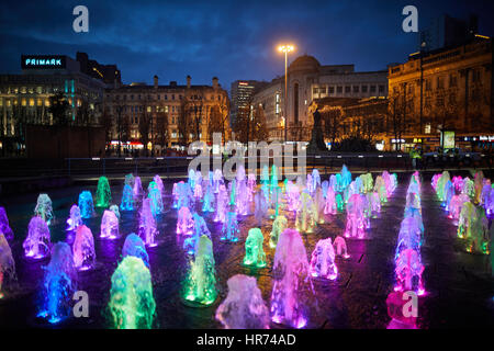 MANCHESTER City Centre, Piccadilly Gardens landmark water fountain display lights at night. Stock Photo