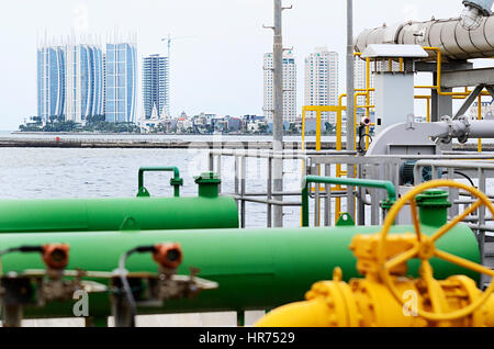 Regatta Tower an iconic Apartement in North Jakarta, Indonesia with the foreground pipe gas LNG instalation Stock Photo