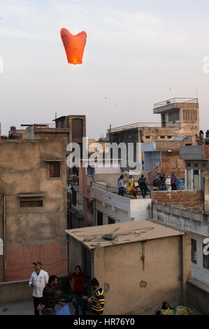 Jaipur, India - 14th Jan 2017: People release a chinese lantern into the air as part of Makar Sankranti or Uttaryan celebration in Rajasthan India. This is a recent trend Stock Photo